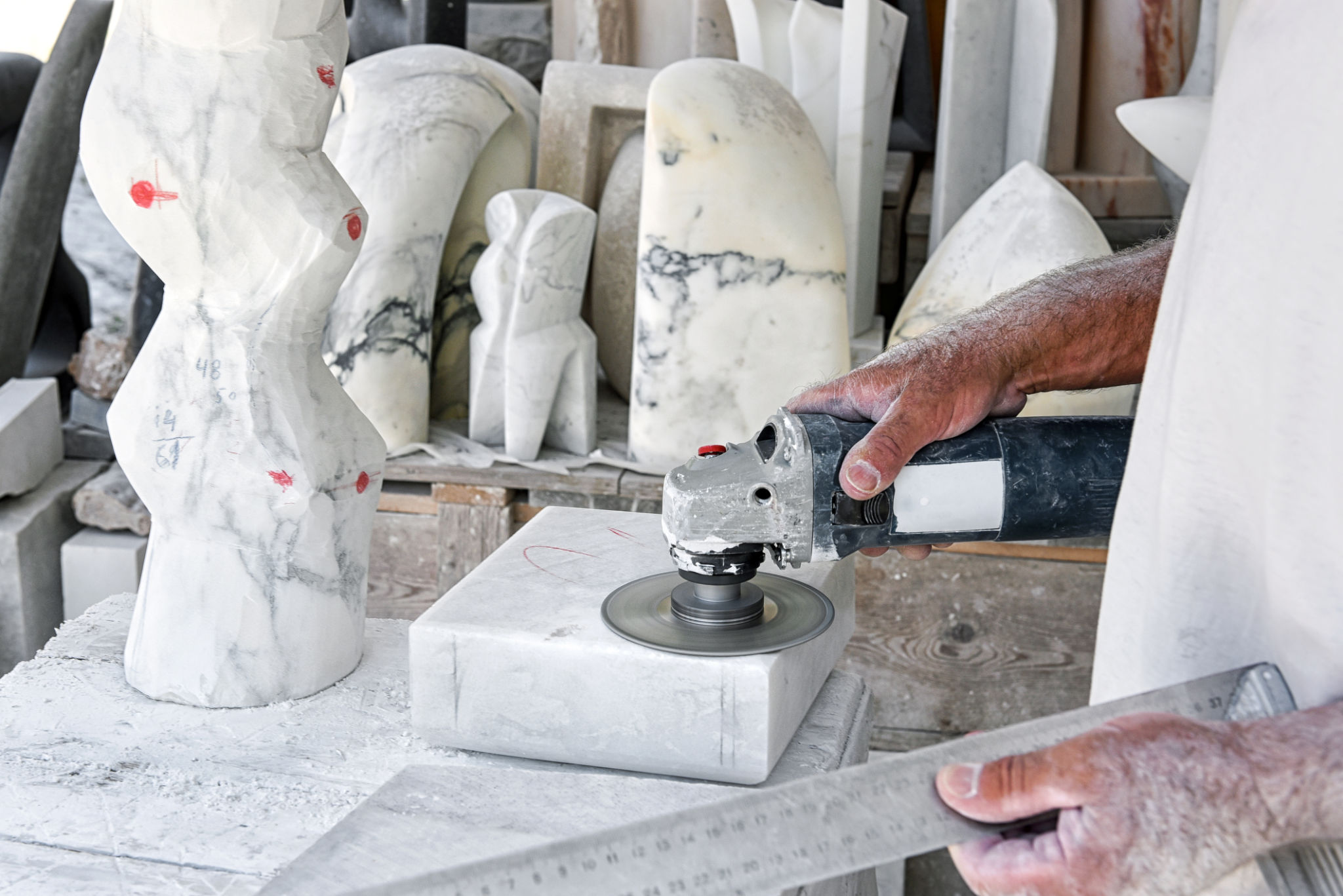 Crop craftsman polishing marble in workshop Crop craftsman polishing marble in workshop