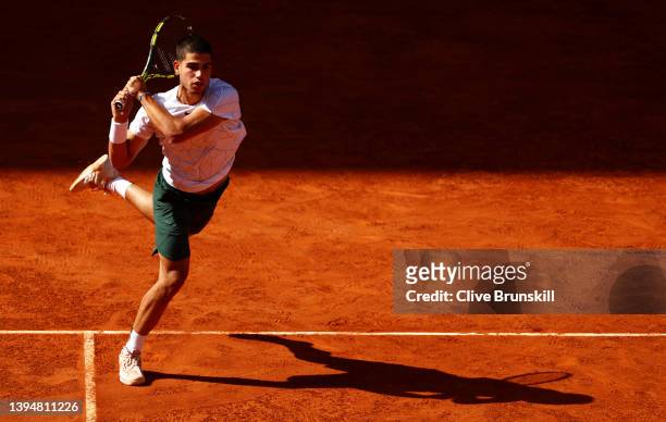 Carlos Alcaraz of Spain plays a backhand during his doubles match with partner Marc Lopez of Spain against Lukasz Kubot of Poland and Edouard...