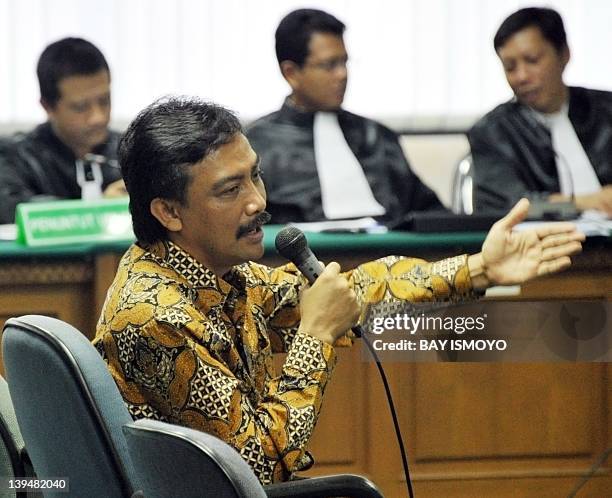 Indonesian Youth and Sports Minister Andi Mallarangeng gestures as he answers the judge's questions at a corruption court in Jakarta on February 22,...