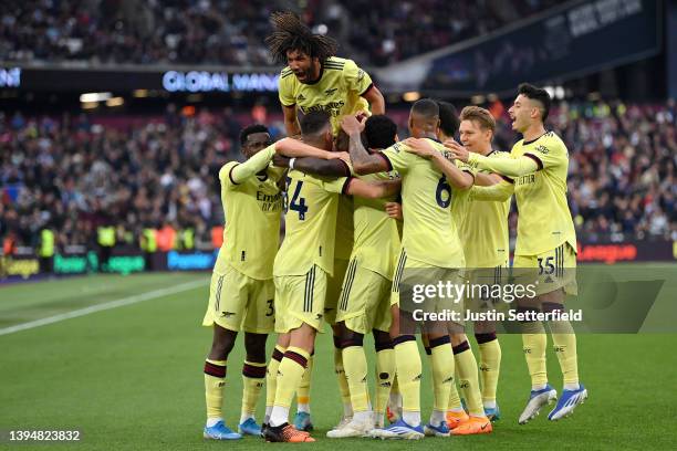 Rob Holding of Arsenal celebrates scoring their side's first goal with teammates during the Premier League match between West Ham United and Arsenal...