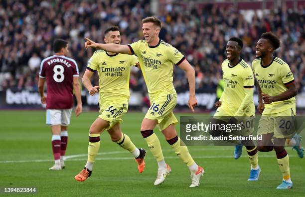 Rob Holding of Arsenal celebrates scoring their side's first goal with teammates during the Premier League match between West Ham United and Arsenal...