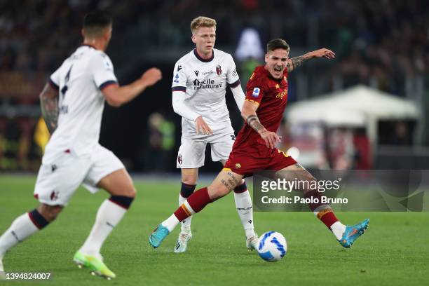 Nicolo Zaniolo of AS Roma is tackled by Jerdy Schouten of Bologna during the Serie A match between AS Roma and Bologna FC at Stadio Olimpico on May...