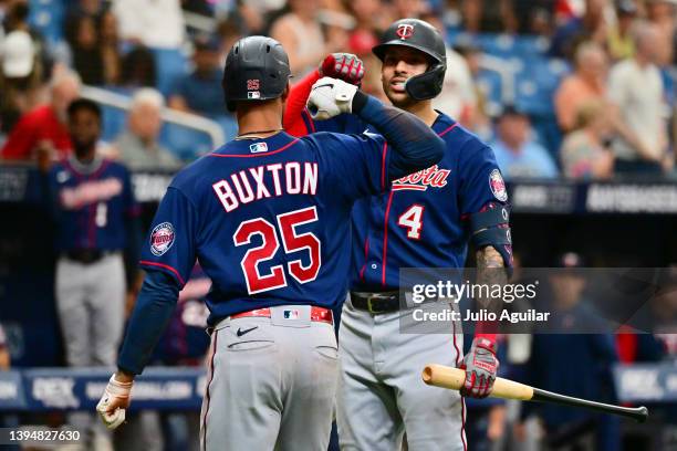 Byron Buxton of the Minnesota Twins celebrates with Carlos Correa after Buxton hit a home run in the fourth inning against the Tampa Bay Rays at...