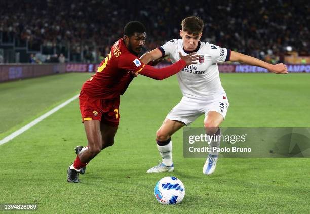 Ainsley Maitland-Niles of AS Roma battles for possession with Aaron Hickey of Bologna during the Serie A match between AS Roma and Bologna FC at...