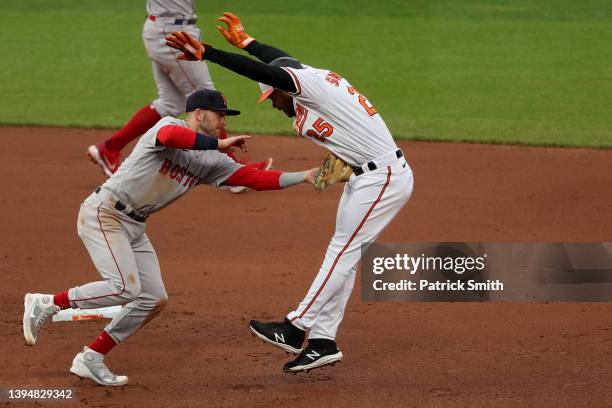 Anthony Santander of the Baltimore Orioles is caught stealing and tagged out by Trevor Story of the Boston Red Sox during the fourth inning at Oriole...