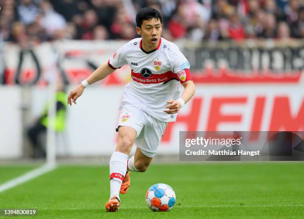 Wataru Endo of VfB Stuttgart controls the ball during the Bundesliga match between VfB Stuttgart and VfL Wolfsburg at Mercedes-Benz Arena on April...