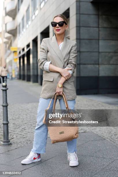 German TV host Tamara von Nayhauss wearing a beige blazer by Zara, light blue denim jeans pants by Zara, a light brown bag by Loop Couture, purple,...