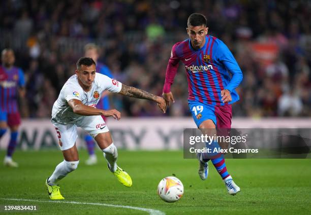 Ferran Torres of FC Barcelona battles for possession with Franco Russo of Real Mallorca during the LaLiga Santander match between FC Barcelona and...