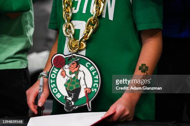 Young fan wears a Boston Celtics chain as he waits for autographs before Game One of the Eastern Conference Semifinals between the Boston Celtics and...