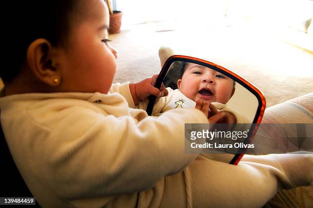 Baby smiles at her reflection