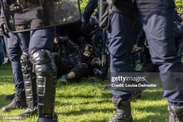 Riot police officers arrest a protester during a May Day rally on May 01, 2022 in Paris, France. Protests on International Workers' Day are an annual...