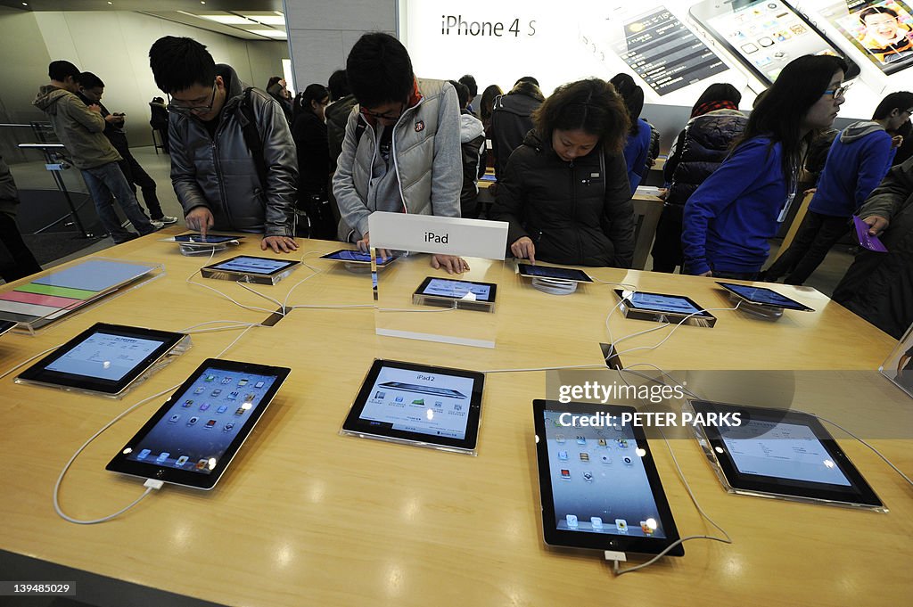 Customers look at Apple iPads at a store