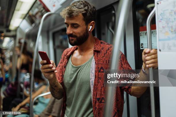 a casual fit for a casual traveler - underground rail stockfoto's en -beelden