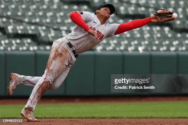 Rafael Devers of the Boston Red Sox cannot make a play on a hit against the Baltimore Orioles during the eighth inning at Oriole Park at Camden Yards...