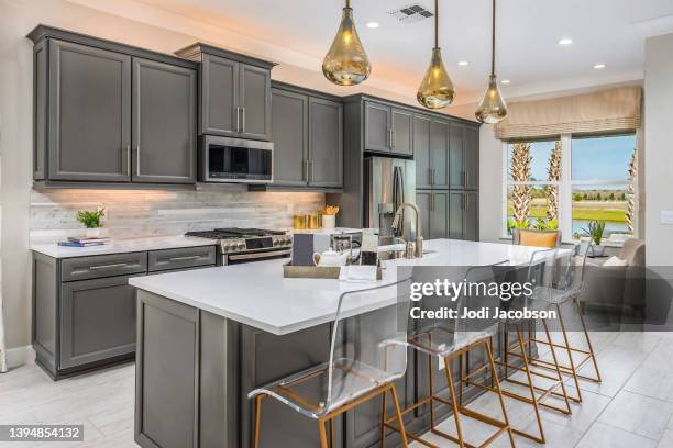 open concept modern  kitchen in a new home - pendant light stockfoto's en -beelden