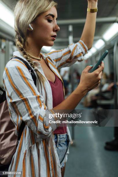 her phone is her best travel companion - looking at subway map bildbanksfoton och bilder