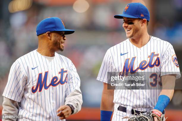 Head basketball coach Shaheen Holloway of the Seton Hall Pirates talks with James McCann of the New York Mets after throwing a ceremonial first pitch...