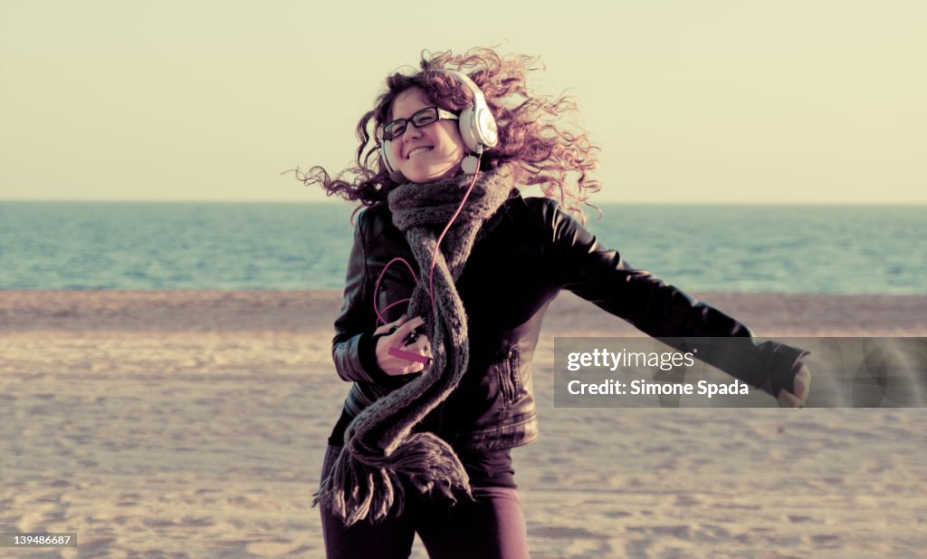 Smiling girl jumping on beach