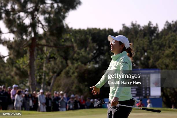 Marina Alex celebrates her putt on the 18th green to finish as the leader at 10 under par and eventual tournament victory during the final round of...