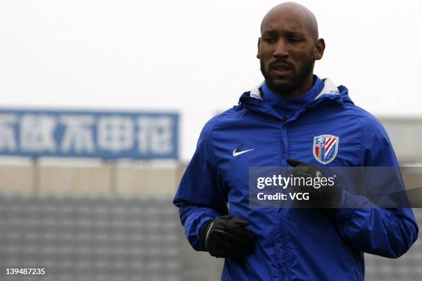 French football player Nicolas Anelka of Shanghai Shenhua warms up prior to a warm-up match between Shanghai Shenhua and Hunan Xiangtao at Shenhua...