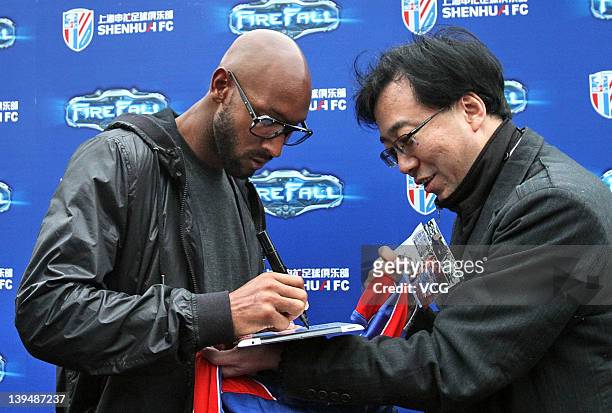 French football player Nicolas Anelka of Shanghai Shenhua signs his autograph for a fan after a warm-up match between Shanghai Shenhua and Hunan...