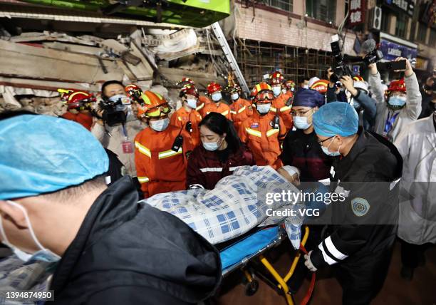 Rescuers transfer a rescued person at the collapse site of a self-constructed residential building on May 1, 2022 in Changsha, Hunan Province of...