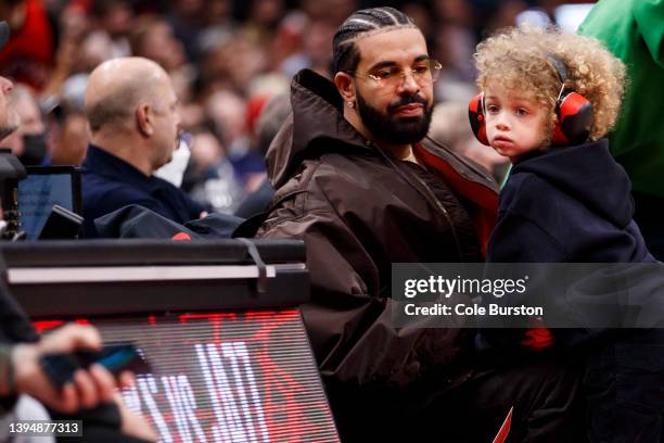 Rapper Drake and his son Adonis take in the Game Six of the Eastern Conference First Round between the Toronto Raptors and the Philadelphia 76ers at...