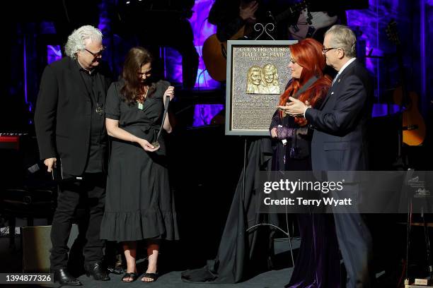 Ashley Judd accepts induction on behalf of Naomi Judd with Ricky Skaggs, inductee Wynonna Judd and CEO of the Country Music Hall of Fame and Museum...