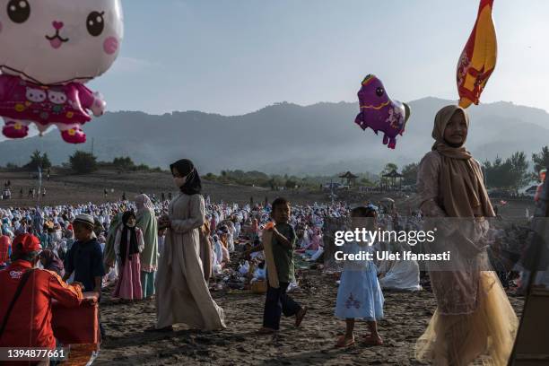 Indonesian Muslims perform Eid Al-Fitr prayer on 'sea of sands' at Parangkusumo beach on May 02, 2022 in Yogyakarta, Indonesia. Muslims around the...