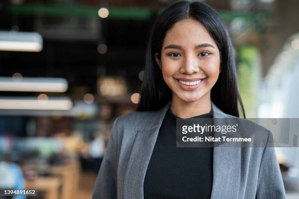 build your people to grow your company. portrait of young female businesswomen in a fin tech business. she is expert in financial management by using technology. - administrative professionals stockfoto's en -beelden