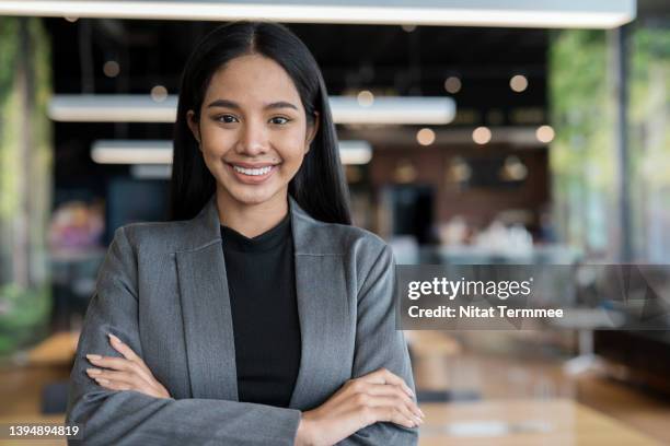 innovation and learn how to manage for young entrepreneurs. portrait of confident businesswoman standing with arms cross in tech business office. - intelligence agency stock pictures, royalty-free photos & images