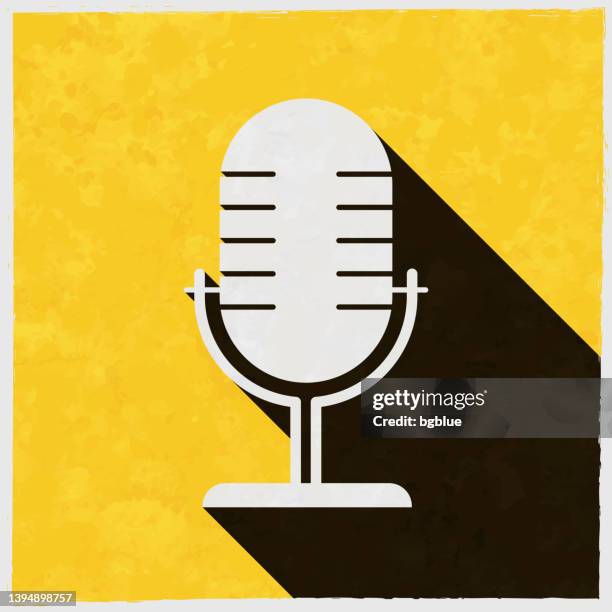 microphone. icon with long shadow on textured yellow background - vinyl press conference stock illustrations