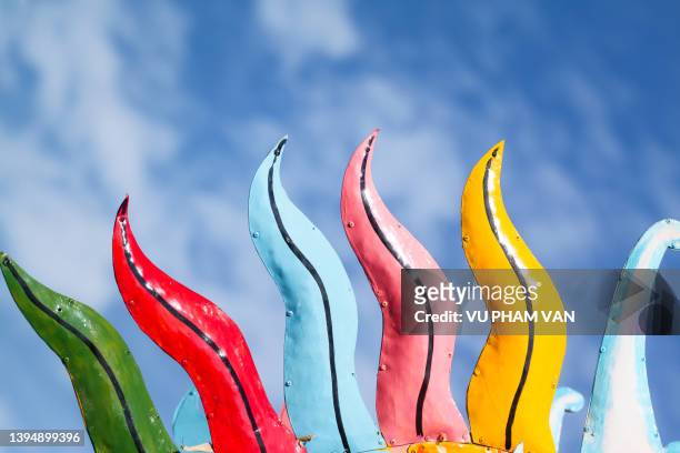 close-up of the colorful hairs of an iron dragon head against the blue sky in hue city, vietnam - rainbow and growth stock pictures, royalty-free photos & images
