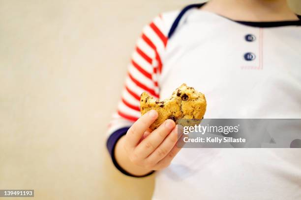 boy holding cookie - biscuit france stock pictures, royalty-free photos & images