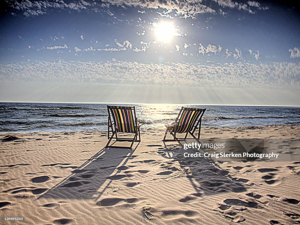 Chairs sitting in sand
