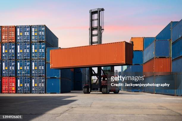 crane lifting up container in yard - cargo containers stock pictures, royalty-free photos & images