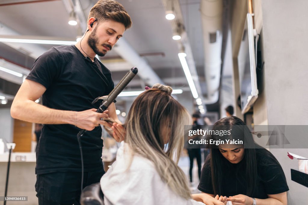 Young woman on manicure treatment at beauty salon