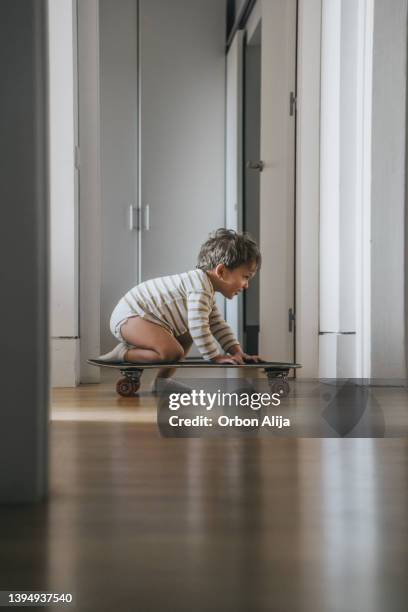 little boy with skate at home - indoor skating stock pictures, royalty-free photos & images