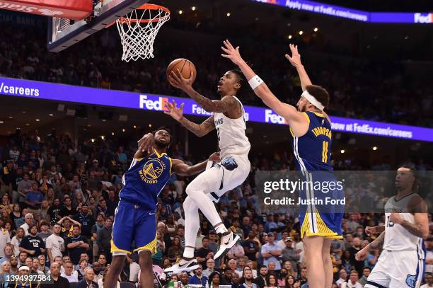 Ja Morant of the Memphis Grizzlies goes to the basket against Andrew Wiggins of the Golden State Warriors during Game One of the Western Conference...