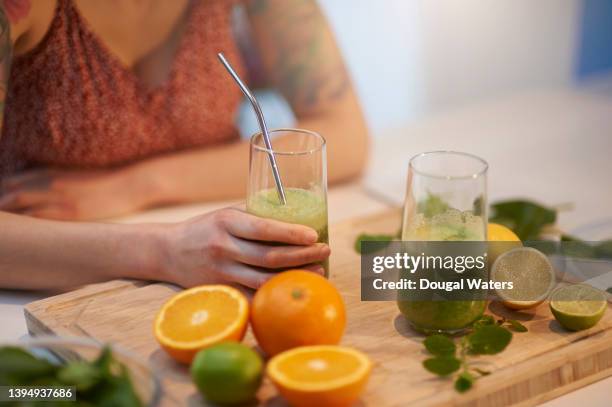 plant based smoothie with citrus fruits, spinach and mint. - orange apple lemon stock pictures, royalty-free photos & images