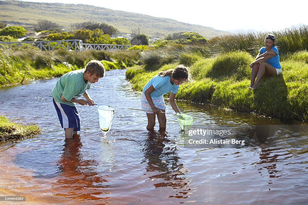 Family playing in stream