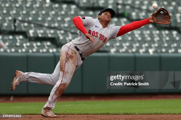 Rafael Devers of the Boston Red Sox cannot make a play on a hit against the Baltimore Orioles during the eighth inning at Oriole Park at Camden Yards...