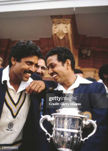 India all rounder Kapil Dev chats with man of the match Mohinder Amarnath, holding the trophy on the balcony after the 1983 Cricket World Cup final...