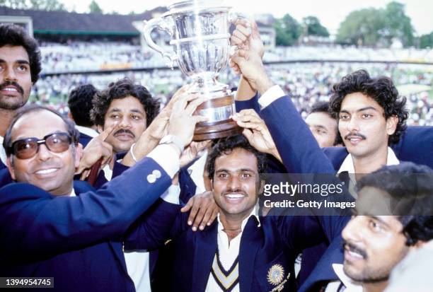 India batsman Yashpal Sharma holds the trophy with squad player Ravi Shastri and team mates on the balcony after the 1983 Cricket World Cup final...