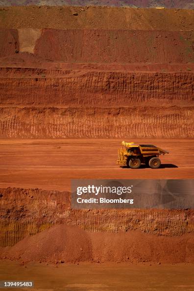Pit Tech Rio Tinto An autonomous haul truck drives through a pit at Rio Tinto Group's ...