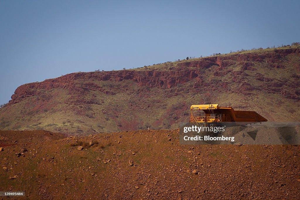 Pit Tech Rio Tinto An autonomous haul truck drives through a pit at Rio Tinto Group's ...