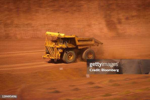 Pit Tech Rio Tinto An autonomous haul truck drives through a pit at Rio Tinto Group's ...