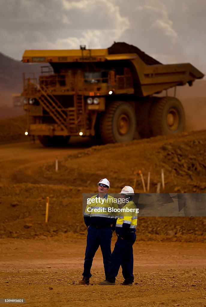 Pit Tech Rio Tinto Mine workers talk as haul trucks operate in the pit at Rio Tinto ...