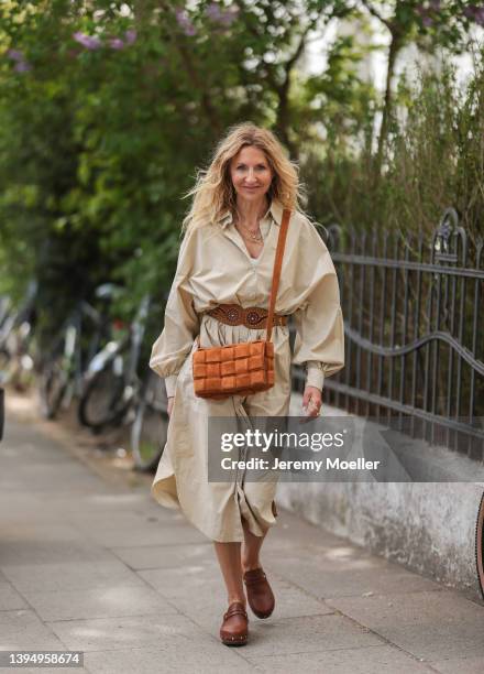 Sue Giers seen wearing a beige midi dress from SoSue, a brown Yves Saint Laurent leather belt, a brown suede leather Bottega Veneta Cassette bag and...