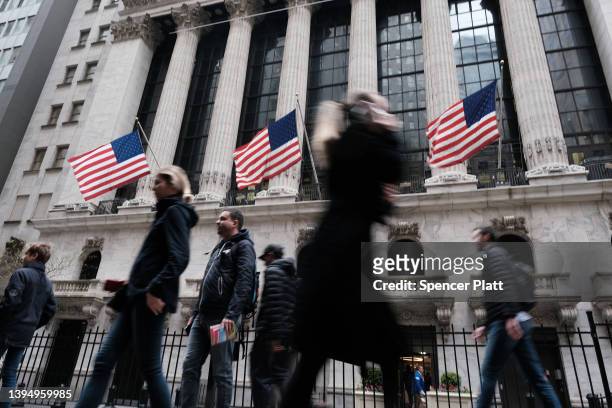 People walk along Wall Street near the New York Stock Exchange on May 02, 2022 in New York City. After falling over 600 points on Friday, stocks were...